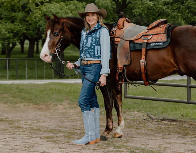 Kristin Kiseljack standing by a horse wearing items from the Tony Lama Ida Mae colleciton.